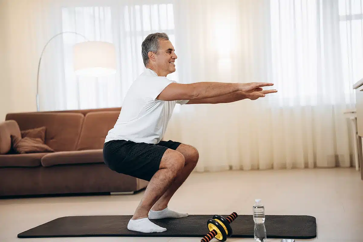 Man doing squat at home